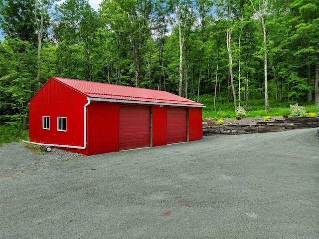 view of outbuilding featuring a forest view and an outdoor structure