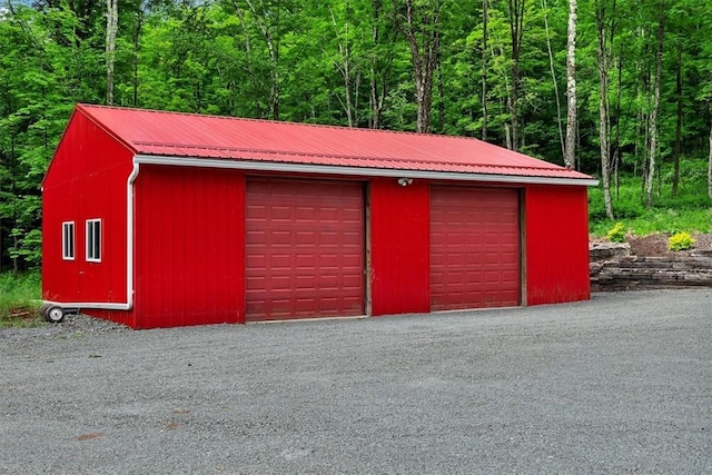 detached garage featuring a forest view