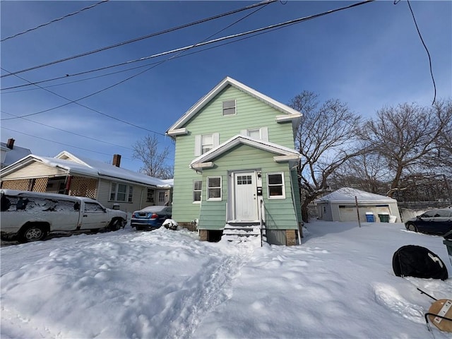 view of front of home with a detached garage