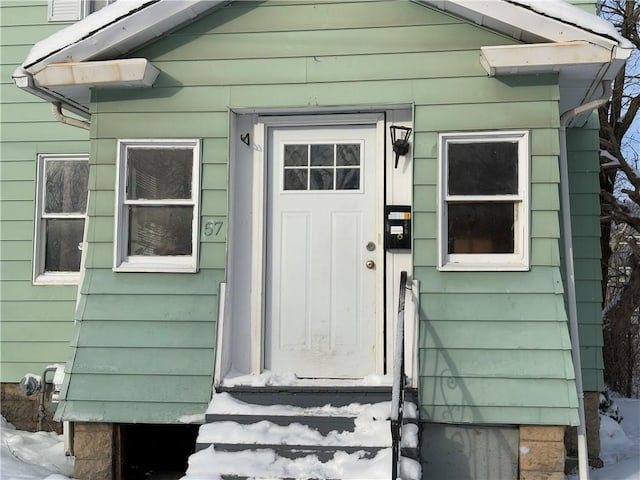 view of snow covered property entrance