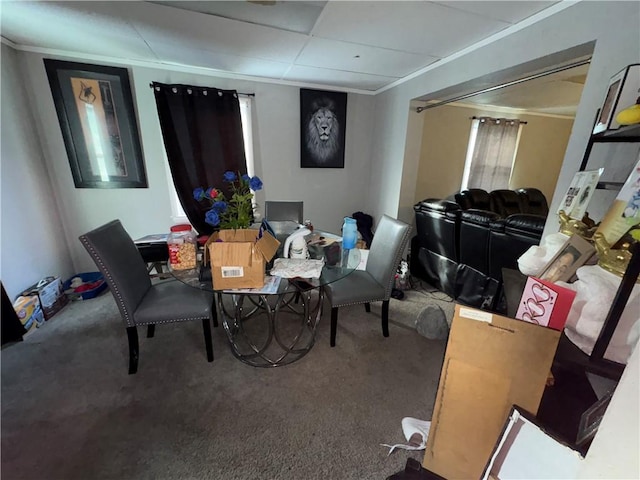 carpeted dining room featuring ornamental molding