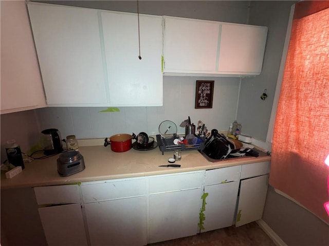 kitchen with light countertops and white cabinetry