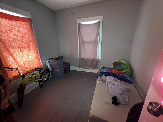 bedroom with wood finished floors and baseboards