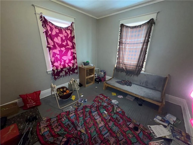 recreation room featuring ornamental molding and baseboards