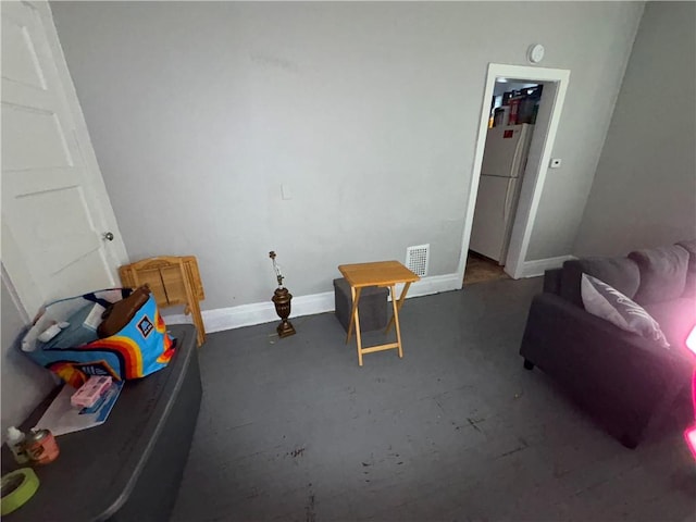 interior space featuring concrete flooring, visible vents, and baseboards