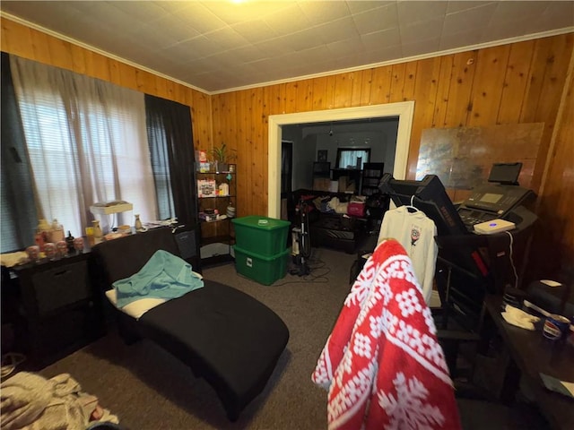 bedroom featuring ornamental molding, carpet, and wooden walls