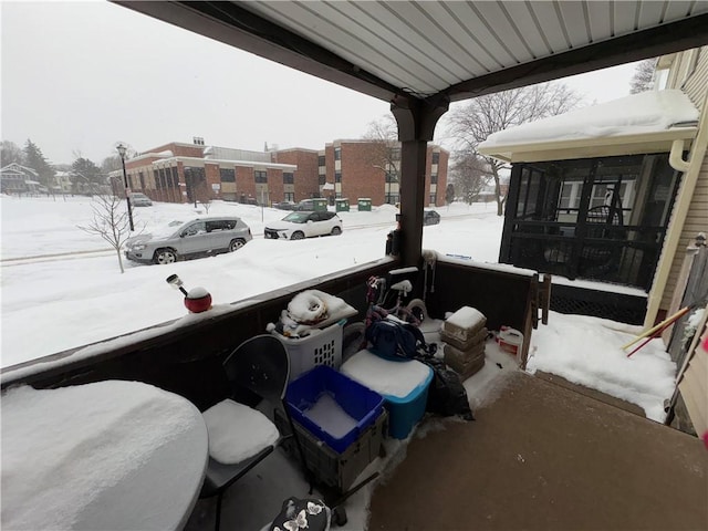 view of snow covered back of property