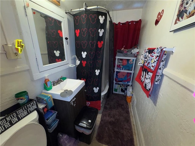 bathroom featuring a stall shower, vanity, and toilet