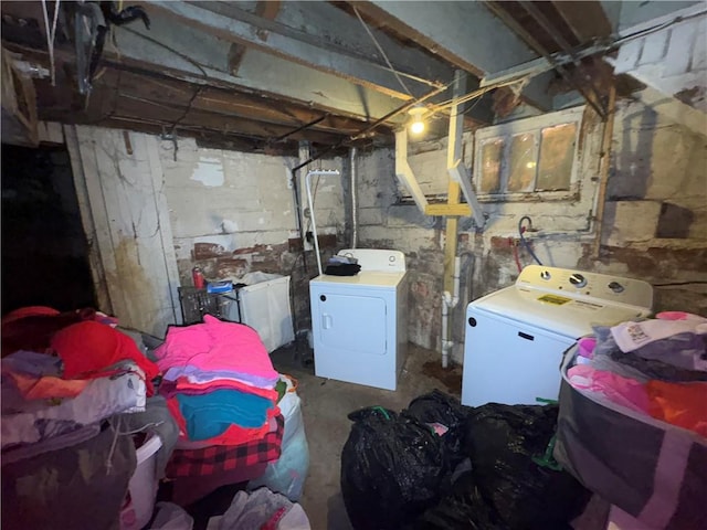 unfinished basement with washing machine and clothes dryer