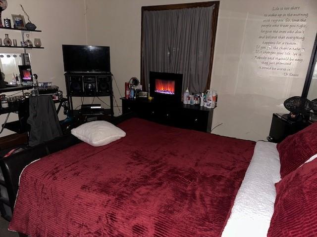 bedroom with a warm lit fireplace