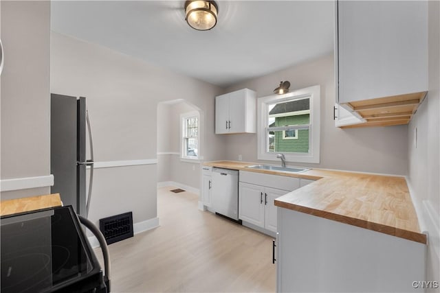 kitchen featuring a sink, electric range, white cabinets, and stainless steel dishwasher