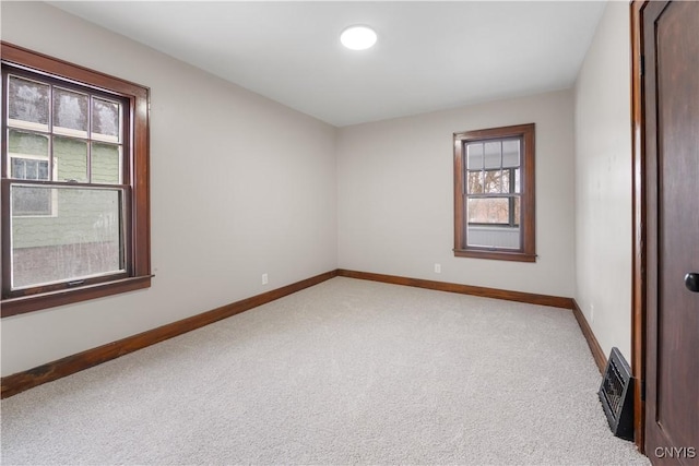 empty room with light carpet and baseboards