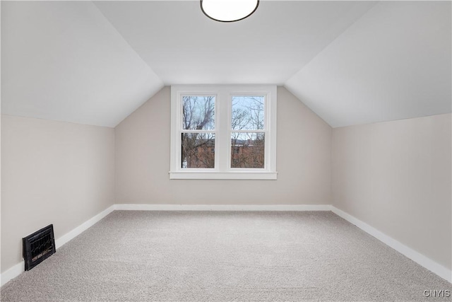 bonus room featuring carpet floors, baseboards, and lofted ceiling