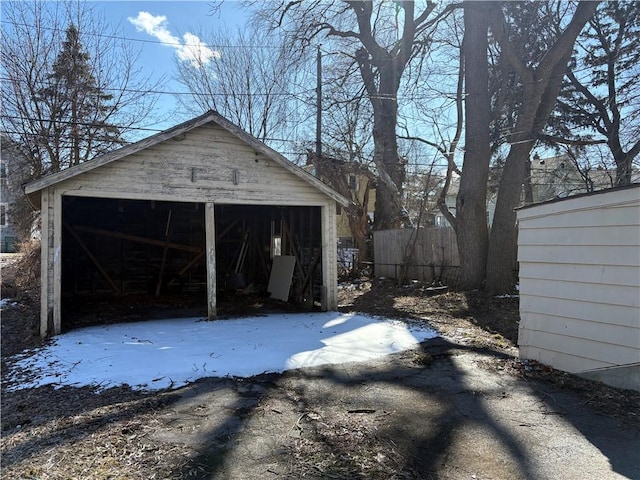 detached garage featuring fence