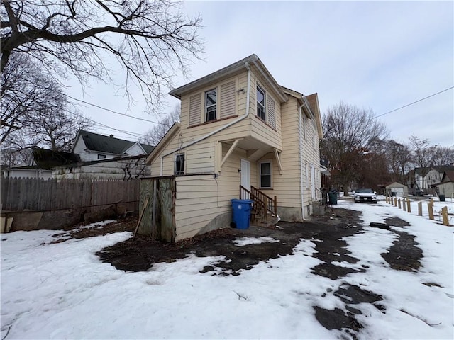 exterior space featuring entry steps and fence