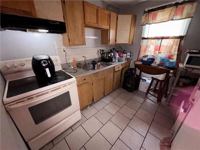 kitchen with light countertops, stainless steel microwave, electric range, decorative backsplash, and under cabinet range hood