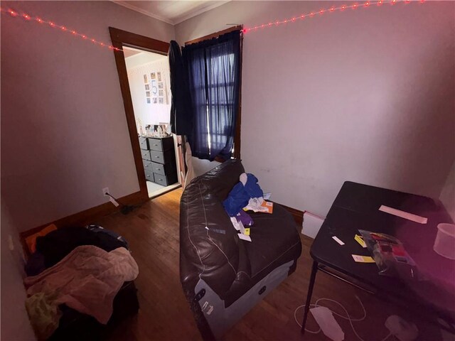 bedroom featuring baseboards and wood finished floors