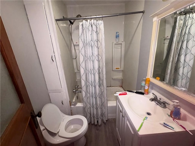 full bath featuring vanity, wood finished floors, toilet, and shower / bathtub combination with curtain