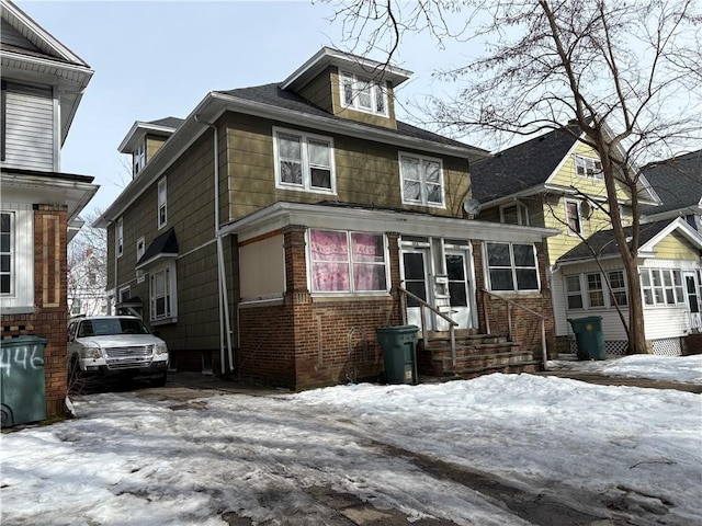 american foursquare style home with entry steps and brick siding