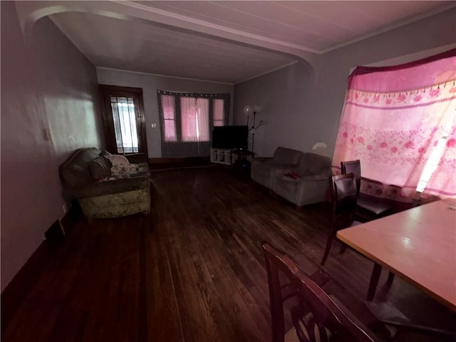 living room featuring crown molding, wood finished floors, and arched walkways