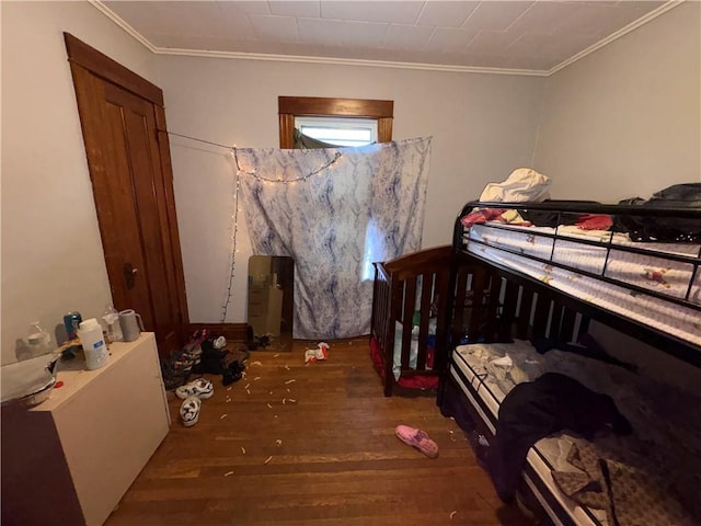 bedroom featuring wood finished floors and ornamental molding