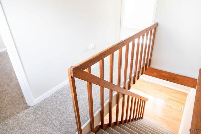 stairs featuring carpet floors and baseboards