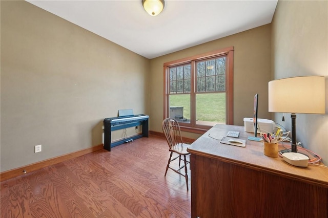 office featuring baseboards and wood finished floors