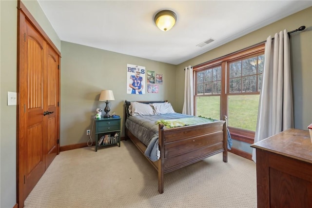 bedroom with light carpet, baseboards, and visible vents