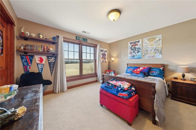 carpeted bedroom featuring baseboards and visible vents