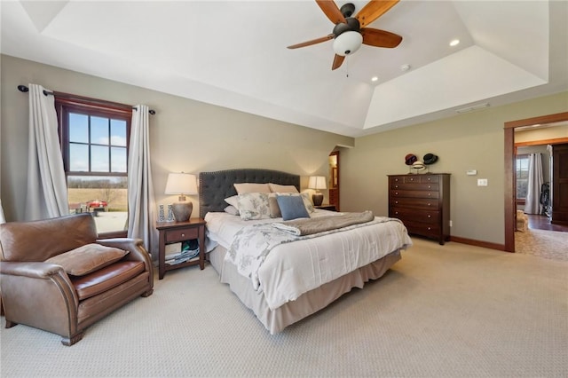 bedroom featuring recessed lighting, light colored carpet, visible vents, baseboards, and a raised ceiling