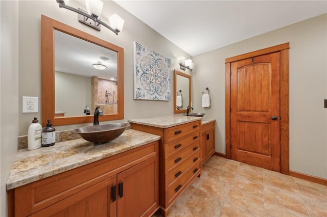 full bathroom with two vanities, a sink, visible vents, and baseboards