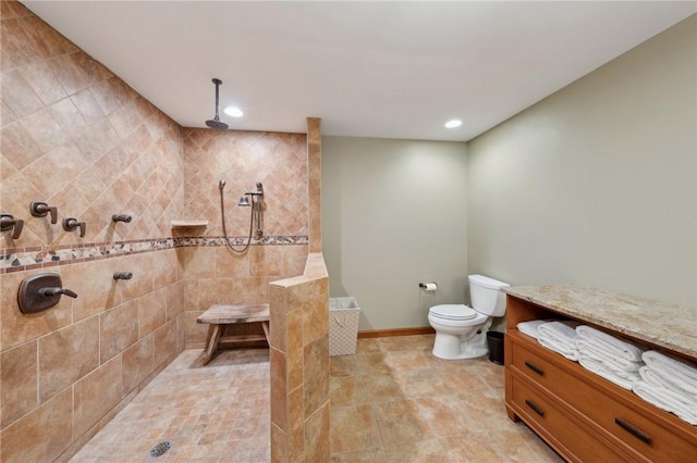 bathroom with recessed lighting, a tile shower, toilet, and baseboards