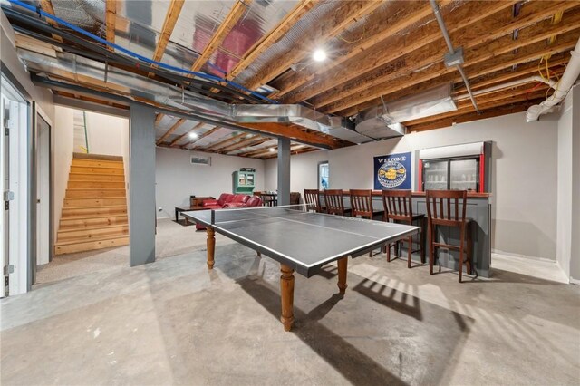 rec room featuring concrete flooring and a dry bar