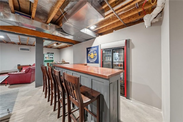 bar with concrete flooring and a bar