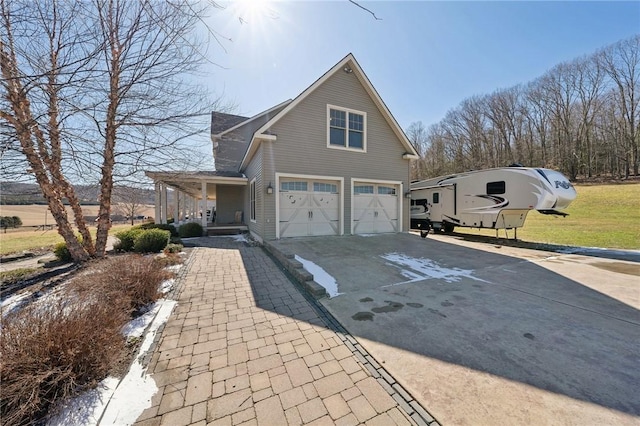 view of front of home featuring a garage, driveway, and a porch