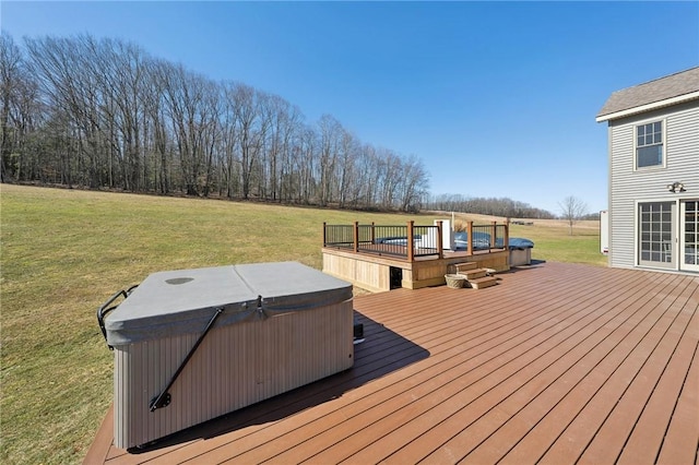 wooden terrace with a hot tub and a lawn