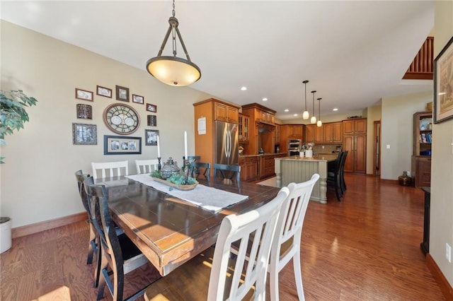 dining area with recessed lighting, wood finished floors, and baseboards