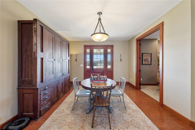 dining room with wood finished floors and baseboards