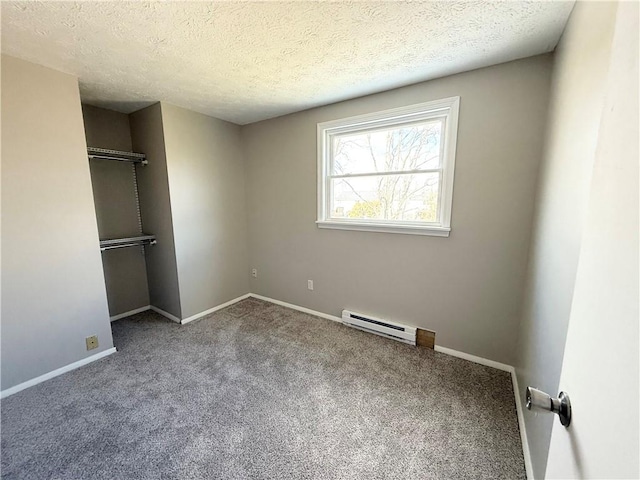 unfurnished bedroom featuring a textured ceiling, a baseboard heating unit, carpet flooring, baseboards, and a closet