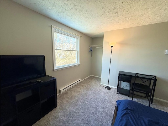 bedroom featuring carpet, baseboards, a textured ceiling, and baseboard heating