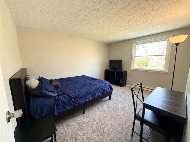 bedroom featuring carpet, baseboards, and a textured ceiling