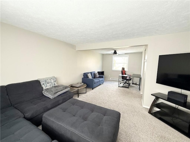 living area featuring a textured ceiling, carpet floors, ceiling fan, and baseboards