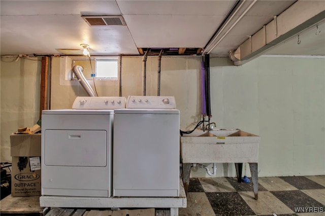 washroom featuring laundry area, washing machine and dryer, visible vents, and tile patterned floors