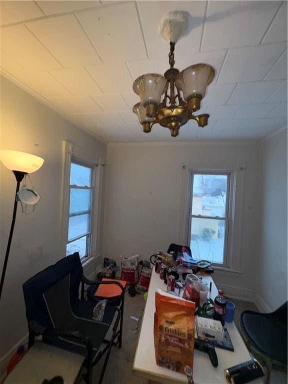 dining area with plenty of natural light, a chandelier, and ornamental molding