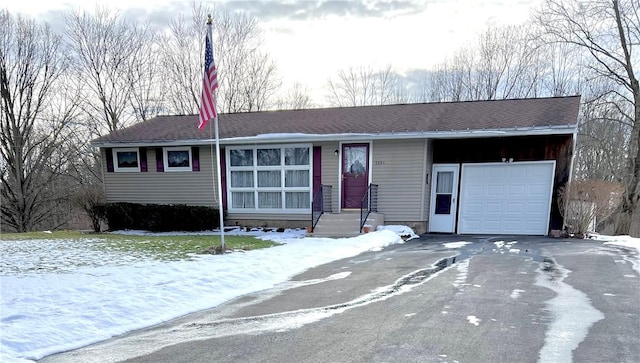 ranch-style house featuring a garage and driveway