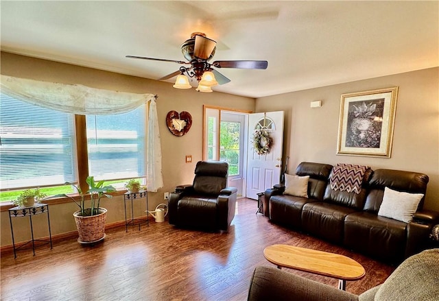 living room featuring ceiling fan, wood finished floors, and baseboards