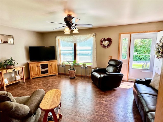 living area with ceiling fan, dark wood finished floors, and baseboards