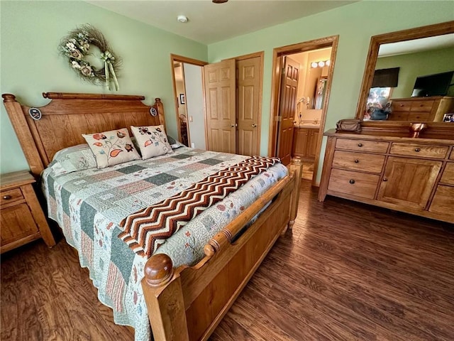 bedroom featuring dark wood-style flooring and connected bathroom