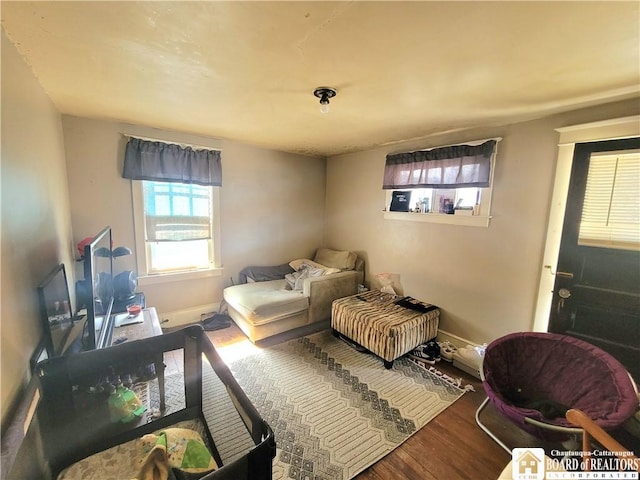 bedroom featuring baseboards and wood finished floors