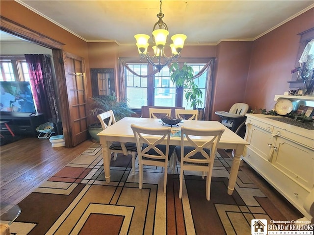 dining space featuring ornamental molding, plenty of natural light, and wood finished floors